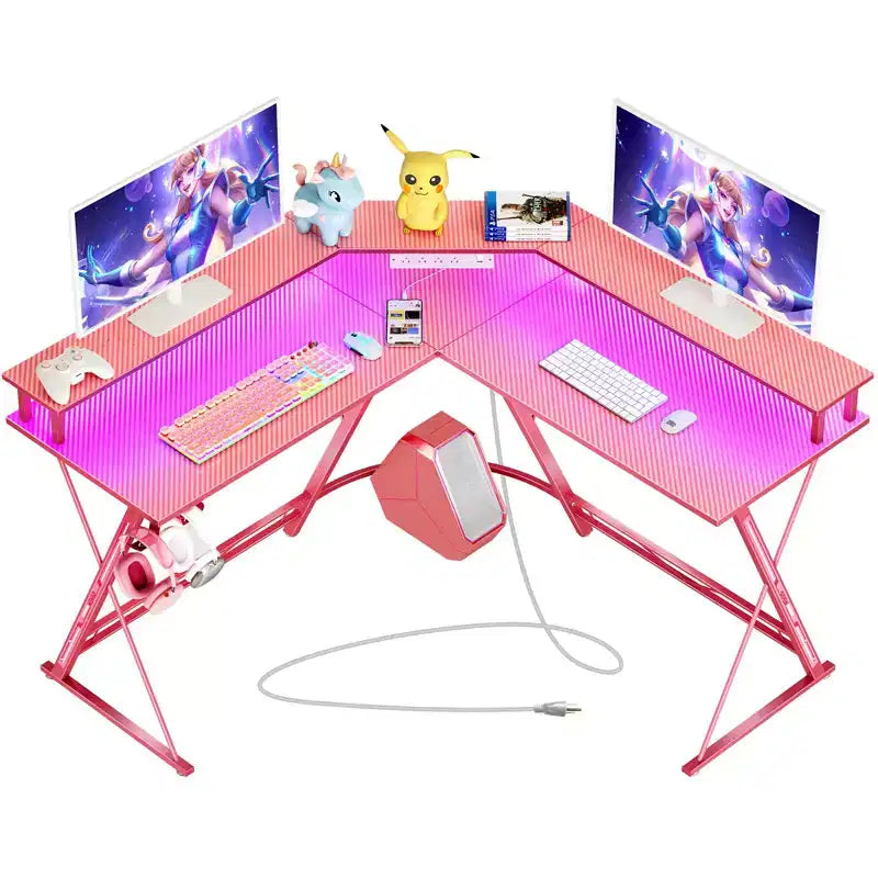 Scrivania a L Greenstell 128 cm – Superficie in fibra di carbonio con luce LED e prese di corrente, tavolo da gaming con supporto per monitor e gancio per cuffie