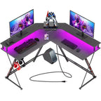 Scrivania a L Greenstell 128 cm – Superficie in fibra di carbonio con luce LED e prese di corrente, tavolo da gaming con supporto per monitor e gancio per cuffie